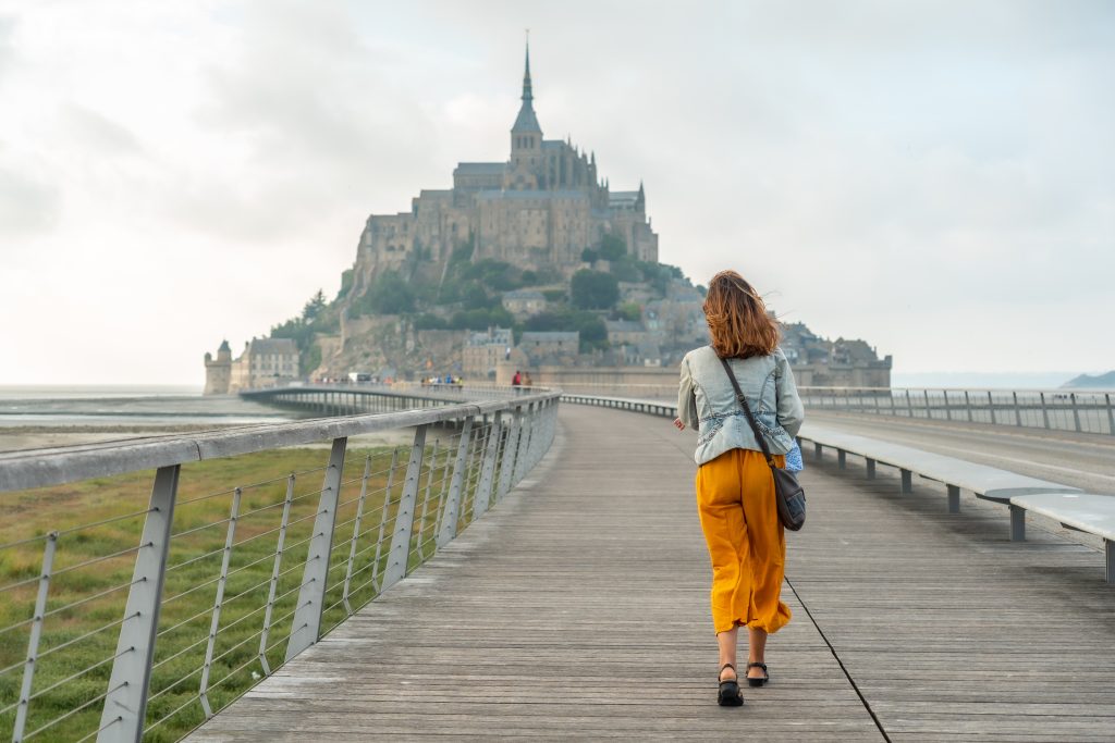 A young tourist visiting the famous Mont Saint-Michel, Normandy region, France